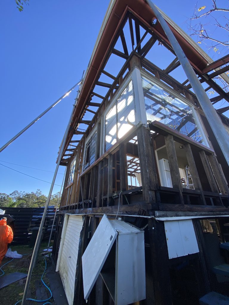 Licensed asbestos removalist in full protective gear handling asbestos safely - SafeZone Asbestos Licensed asbestos removalist in full protective gear handling asbestos safely