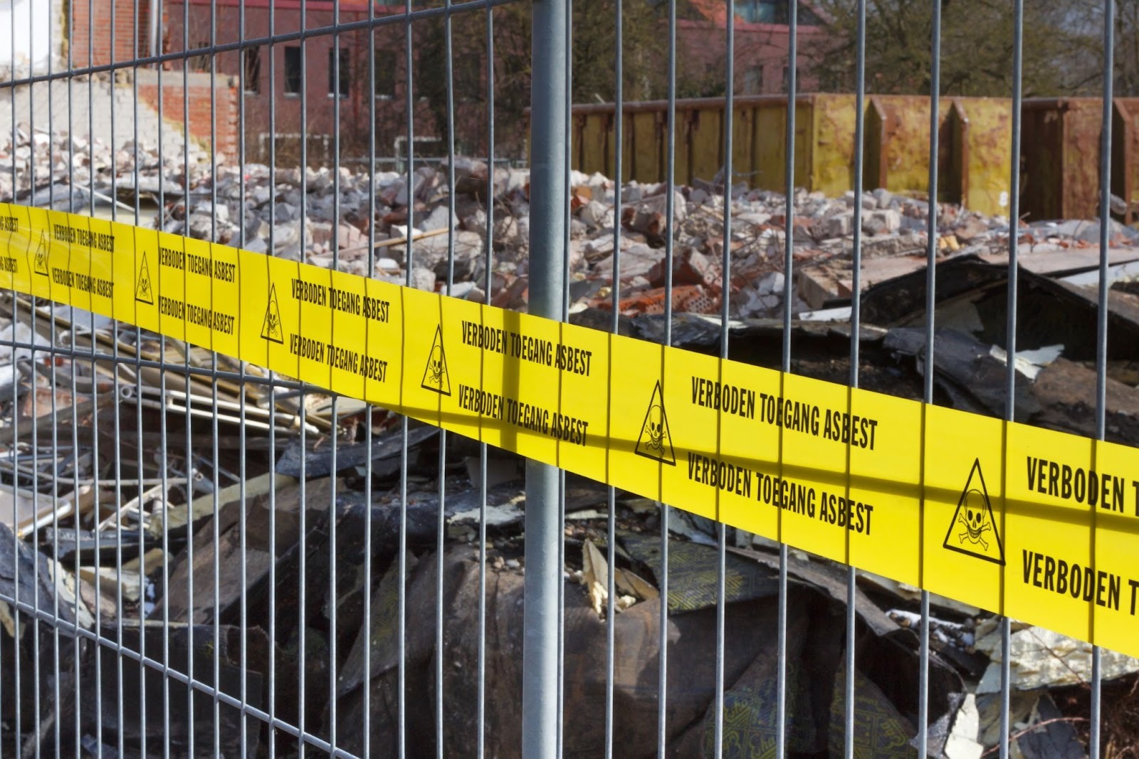 Asbestos warning tape and temporary fencing securing an asbestos removal site in Brisbane
